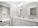 Bathroom featuring double sinks, granite countertops, and marble-tiled shower at 1004 E Sandy Ridge Rd, Monroe, NC 28112