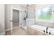 Bathroom featuring soaking tub, glass shower, and tile surround at 1004 E Sandy Ridge Rd, Monroe, NC 28112
