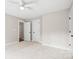 Spacious carpeted bedroom with two closets and two doors leading out of the room at 1004 E Sandy Ridge Rd, Monroe, NC 28112