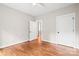An empty bedroom featuring hardwood floors, modern trim, and a neutral wall color at 1004 E Sandy Ridge Rd, Monroe, NC 28112