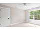 Well-lit bedroom with a window view of the surrounding trees and outdoor space at 1004 E Sandy Ridge Rd, Monroe, NC 28112