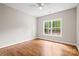 Bright bedroom with hardwood floors and a large window overlooking a private backyard at 1004 E Sandy Ridge Rd, Monroe, NC 28112