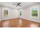 Large bedroom featuring hardwood floors and natural light from three windows at 1004 E Sandy Ridge Rd, Monroe, NC 28112