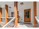 Inviting front porch features wooden columns, rocking chairs, a 'Welcome' mat, and a charming wood front door at 1004 E Sandy Ridge Rd, Monroe, NC 28112
