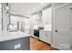 Bright kitchen with stainless steel appliances, white cabinets, and wood floors at 1004 E Sandy Ridge Rd, Monroe, NC 28112