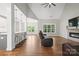 Inviting living room with modern fireplace, hardwood floors, and an open layout flowing into the breakfast bar and kitchen at 1004 E Sandy Ridge Rd, Monroe, NC 28112