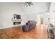 Spacious living room with a fireplace, ceiling fan, and wood floors at 1004 E Sandy Ridge Rd, Monroe, NC 28112