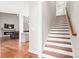 View of staircase and part of open plan living room with fireplace at 1004 E Sandy Ridge Rd, Monroe, NC 28112