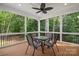 Inviting screened-in porch with table, chairs, and beautiful views of surrounding trees at 1004 E Sandy Ridge Rd, Monroe, NC 28112