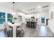 Open-concept dining area with modern table, chairs, and kitchen with stainless steel appliances in background at 10339 Lakeshore Dr # 85, Lancaster, SC 29720