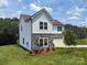 Attractive two-story home featuring stone accents, a manicured lawn, and mature trees at 10339 Lakeshore Dr # 85, Lancaster, SC 29720