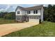 Beautiful new construction home with stone facade, attached garage, and a fresh, green lawn at 10339 Lakeshore Dr # 85, Lancaster, SC 29720