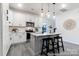Well-lit kitchen with white cabinets, stainless steel appliances, island, and modern pendant lights at 10339 Lakeshore Dr # 85, Lancaster, SC 29720