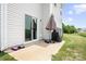 View of the back patio with sliding glass doors and a covered grill on a well-maintained lawn at 106 Tuppy Ct, Statesville, NC 28625
