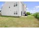 Spacious backyard featuring a well-maintained lawn, patio area, and lush greenery at 106 Tuppy Ct, Statesville, NC 28625