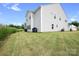 A spacious backyard with a well-kept lawn surrounds a two-story house at 106 Tuppy Ct, Statesville, NC 28625