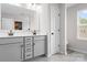 Modern bathroom with double sinks, gray cabinets and a toilet area at 106 Tuppy Ct, Statesville, NC 28625