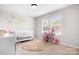 Bright Bedroom with pink accents and a crib at 106 Tuppy Ct, Statesville, NC 28625