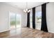 Bright dining area with wood flooring, a chandelier, and natural light from a sliding glass door and windows at 106 Tuppy Ct, Statesville, NC 28625
