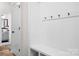 Bright entryway with coat hooks, bench, and adjacent view into a bathroom at 106 Tuppy Ct, Statesville, NC 28625