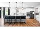 Modern kitchen with white cabinetry, stainless steel appliances, and a large island with bar seating at 106 Tuppy Ct, Statesville, NC 28625