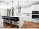 Spacious kitchen with an island, seating, stainless steel appliances, and modern lighting at 106 Tuppy Ct, Statesville, NC 28625