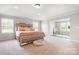 Spacious main bedroom featuring a tray ceiling, neutral carpeting, and decorative accents at 106 Tuppy Ct, Statesville, NC 28625