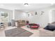 Spacious playroom with trampoline, rug, and tan couches at 106 Tuppy Ct, Statesville, NC 28625
