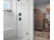 Beautiful tiled shower with a built-in bench and an open closet at 106 Tuppy Ct, Statesville, NC 28625