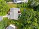 Aerial view of the property showcasing a manicured lawn, mature trees, a pool, and a trampoline at 10919 Valley Spring Dr, Charlotte, NC 28277