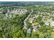 High aerial view of a residential neighborhood surrounded by lush trees and offering a serene living environment at 10919 Valley Spring Dr, Charlotte, NC 28277