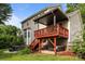 Exterior shot of a two-story home with a wooden deck, a hot tub, and backyard space at 10919 Valley Spring Dr, Charlotte, NC 28277