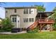 Backyard view with a hot tub, outdoor seating, a grill and an elevated covered deck at 10919 Valley Spring Dr, Charlotte, NC 28277