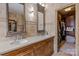 Bathroom with dual sinks, stone walls and a walk-in closet at 10919 Valley Spring Dr, Charlotte, NC 28277