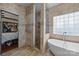 This bathroom features a standalone bathtub, tiled shower and a window at 10919 Valley Spring Dr, Charlotte, NC 28277