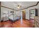 Bedroom with four poster bed, decorative ceiling fan and hardwood floors at 10919 Valley Spring Dr, Charlotte, NC 28277