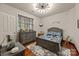 Bedroom with gray wooden floors and a modern ceiling light at 10919 Valley Spring Dr, Charlotte, NC 28277