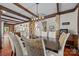Beautiful dining room with wood beams, stone accents and decorative chairs at 10919 Valley Spring Dr, Charlotte, NC 28277