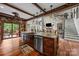 Custom kitchen island with stone accents, stainless steel appliances and hardwood floors at 10919 Valley Spring Dr, Charlotte, NC 28277
