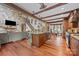 Spacious living area with stone fireplace, wood beams and modern kitchen island at 10919 Valley Spring Dr, Charlotte, NC 28277