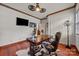 Comfortable home office with an executive desk, a cowhide rug, and a ceiling fan at 10919 Valley Spring Dr, Charlotte, NC 28277