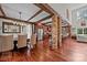 Open-concept kitchen and dining area with hardwood floors and exposed wooden beams at 10919 Valley Spring Dr, Charlotte, NC 28277