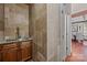 Wet bar area featuring stone walls, wooden cabinets and sink at 10919 Valley Spring Dr, Charlotte, NC 28277