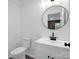 Modern bathroom featuring a round mirror, stylish vanity, and sleek fixtures at 111 Wolfe Rd, Shelby, NC 28152