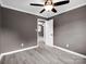 This bedroom offers neutral walls, a ceiling fan, and durable light wood-look flooring at 111 Wolfe Rd, Shelby, NC 28152