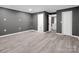 Large bedroom with doors leading to the bathroom and hallway, and new gray flooring at 111 Wolfe Rd, Shelby, NC 28152