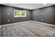 Spacious bedroom with modern gray walls, white trim and waterproof gray flooring at 111 Wolfe Rd, Shelby, NC 28152