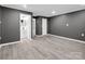 Modern bedroom with gray walls, doors leading to bathroom, hall, and closets plus gray flooring at 111 Wolfe Rd, Shelby, NC 28152