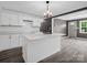 Stylish kitchen with white cabinets, an island with seating, and pendant lighting above island at 111 Wolfe Rd, Shelby, NC 28152
