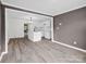 Open layout showcasing the waterproof floors, gray walls, and white kitchen with island at 111 Wolfe Rd, Shelby, NC 28152